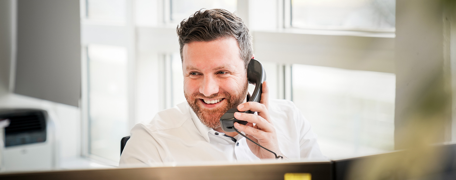 Testo employee laughs and makes a phone call